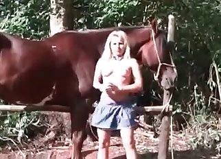 Sweet cowgirl is sucking a stallion's boner
